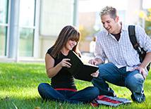 Students Sitting on lawn studying
